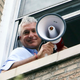 Donziger in the window of his Manhattan apartment in August 2021.